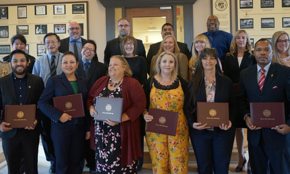 Group of people holding certificates